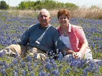 Cecily & Al sitting in Texas Bluebonnet field